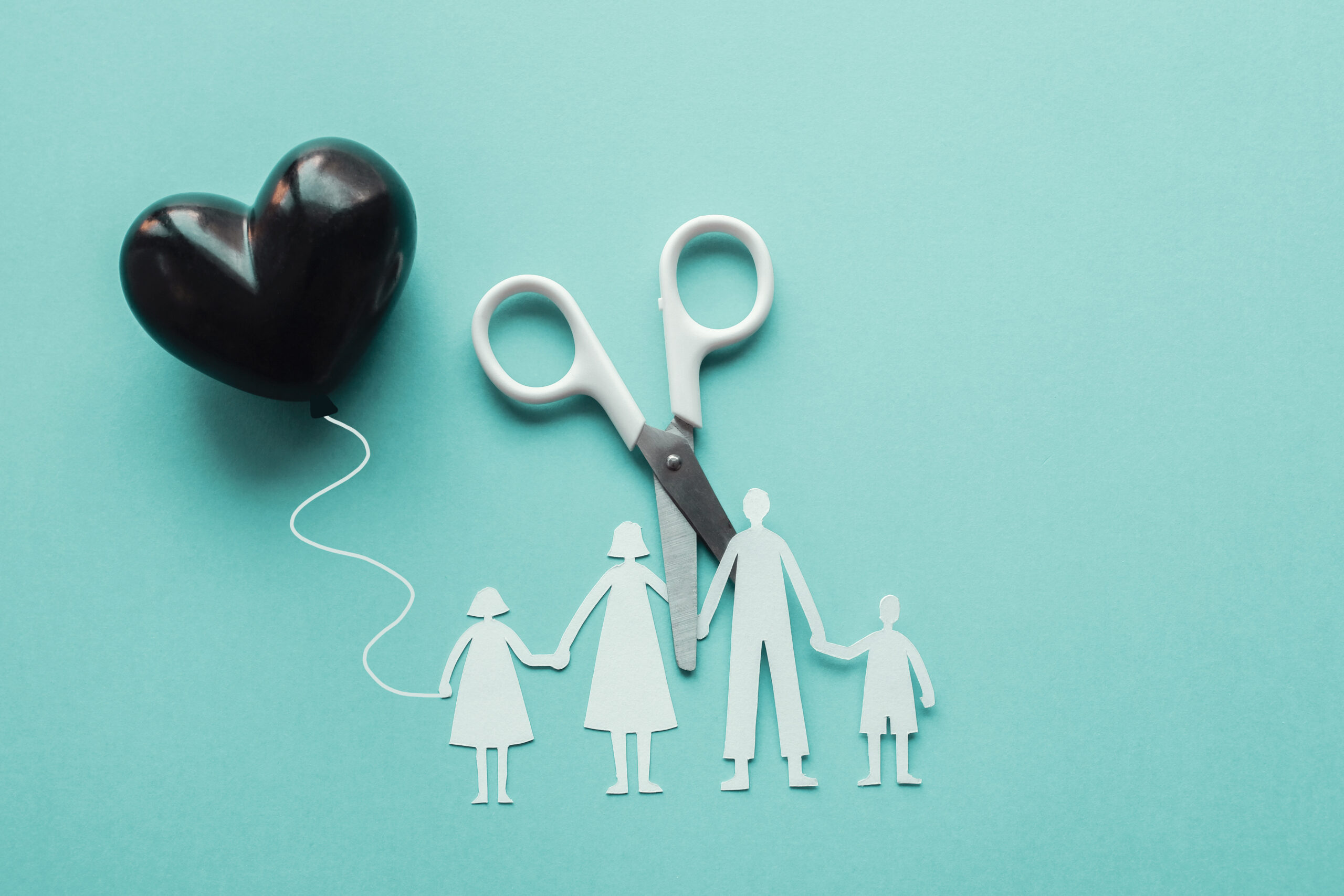 balloon heart paper cut out of family with scissors