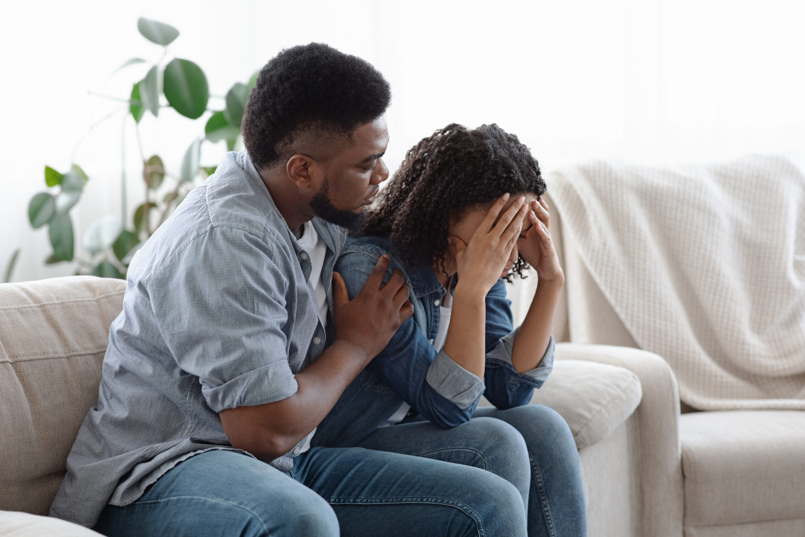 couple sad on the couch