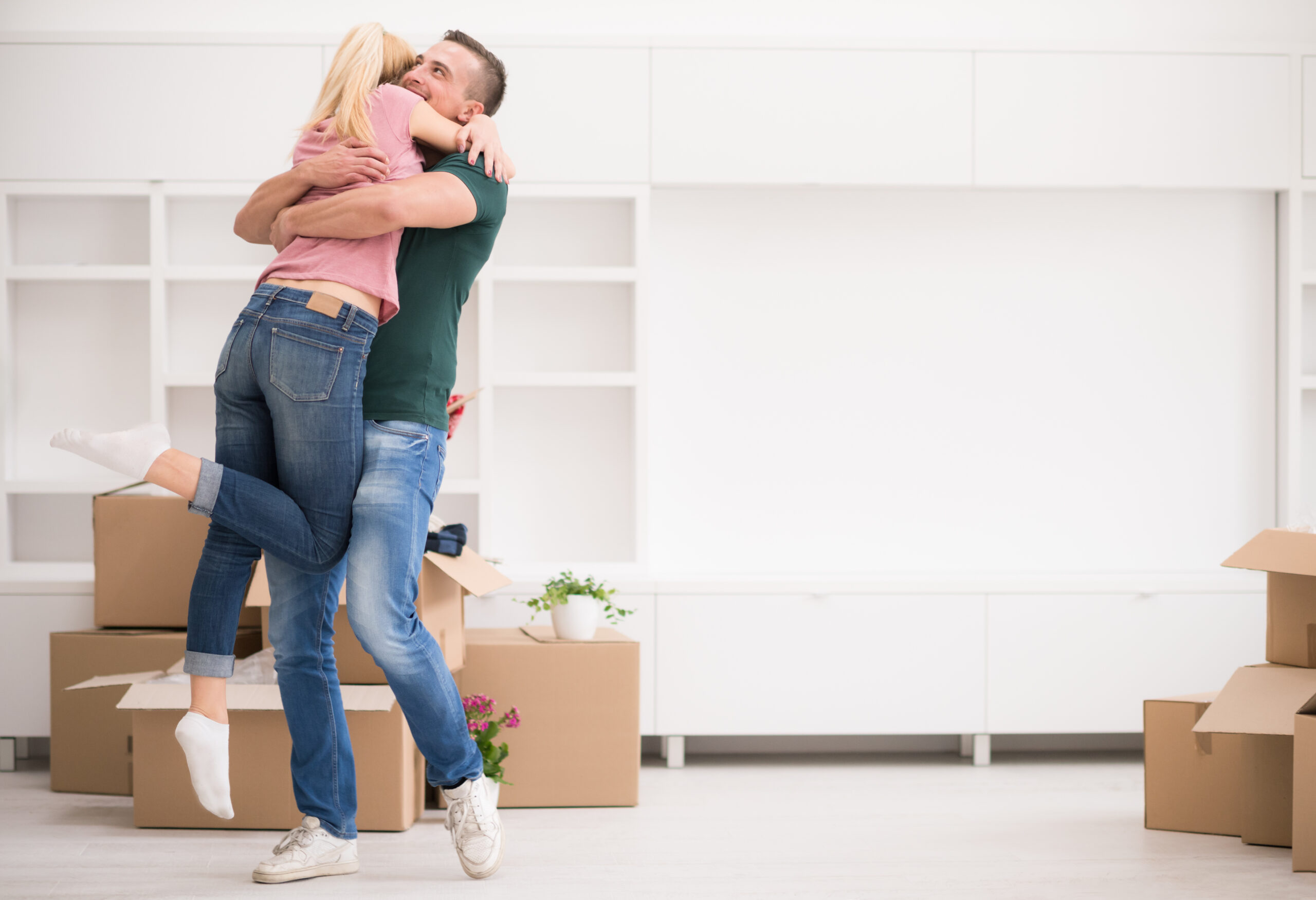 happy young couple moving in new house