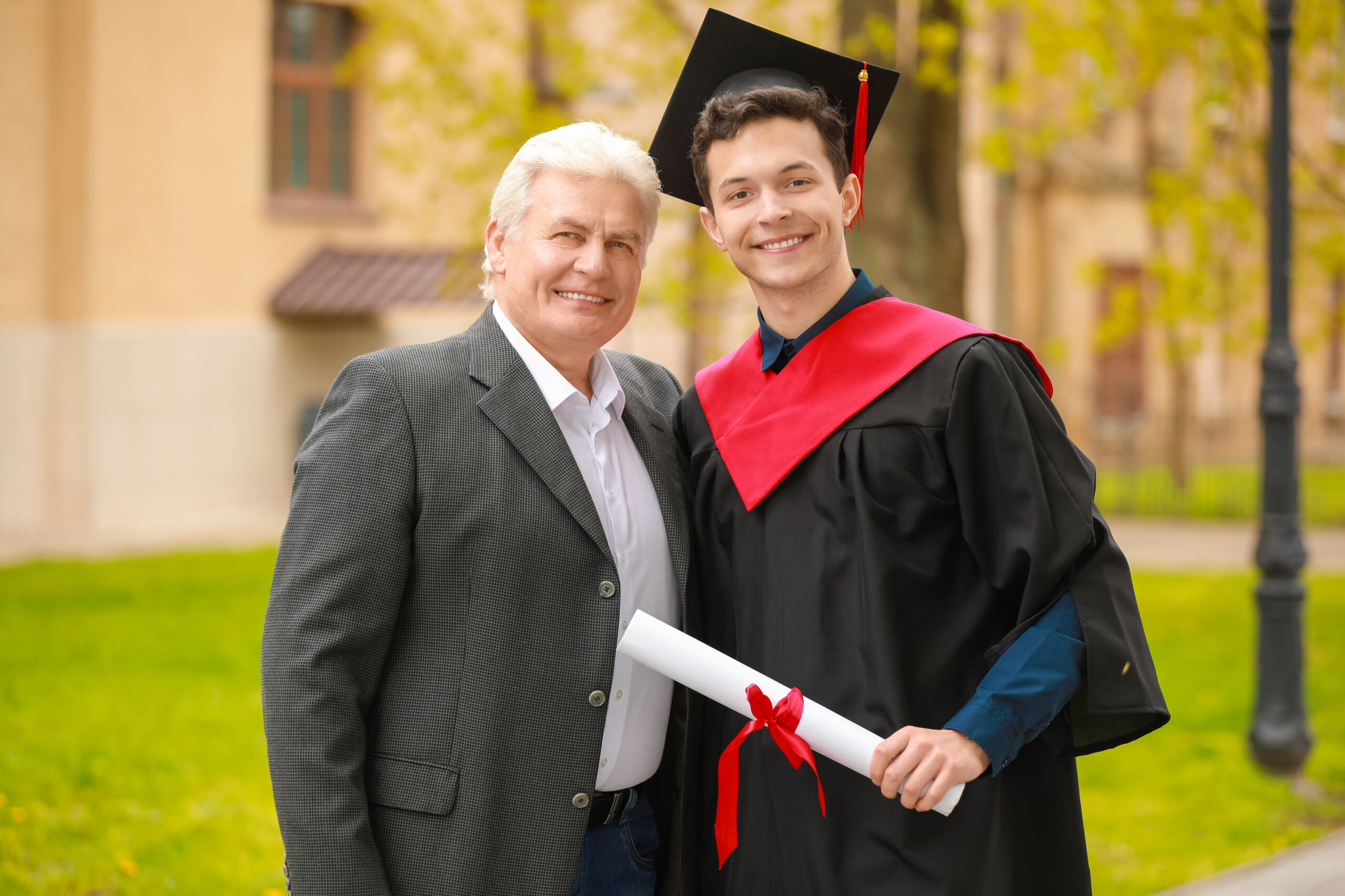 Happy young man with his father on graduation day