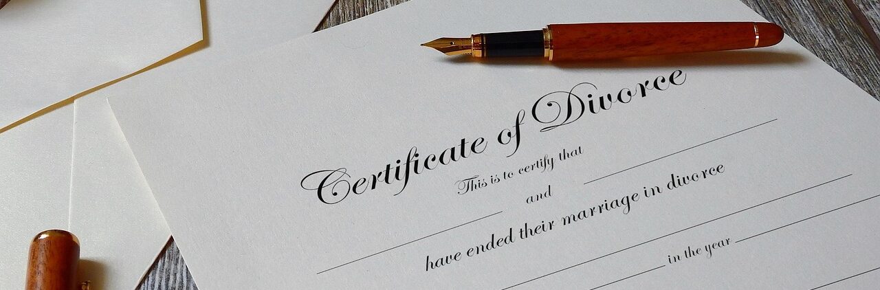 Certificate of divorce prepared for signing on a desk with fountain pen; Middlesex County Divorce Attorney concept image