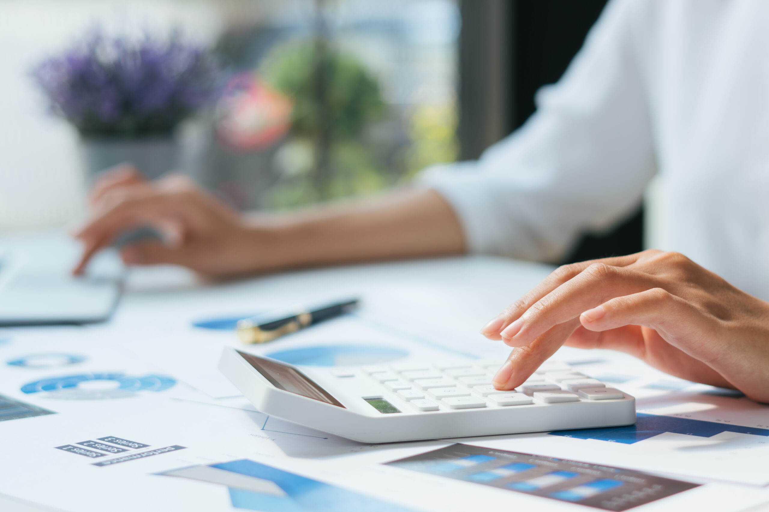 Business accounting concept, Business man using calculator with computer laptop, budget and loan paper in office.
